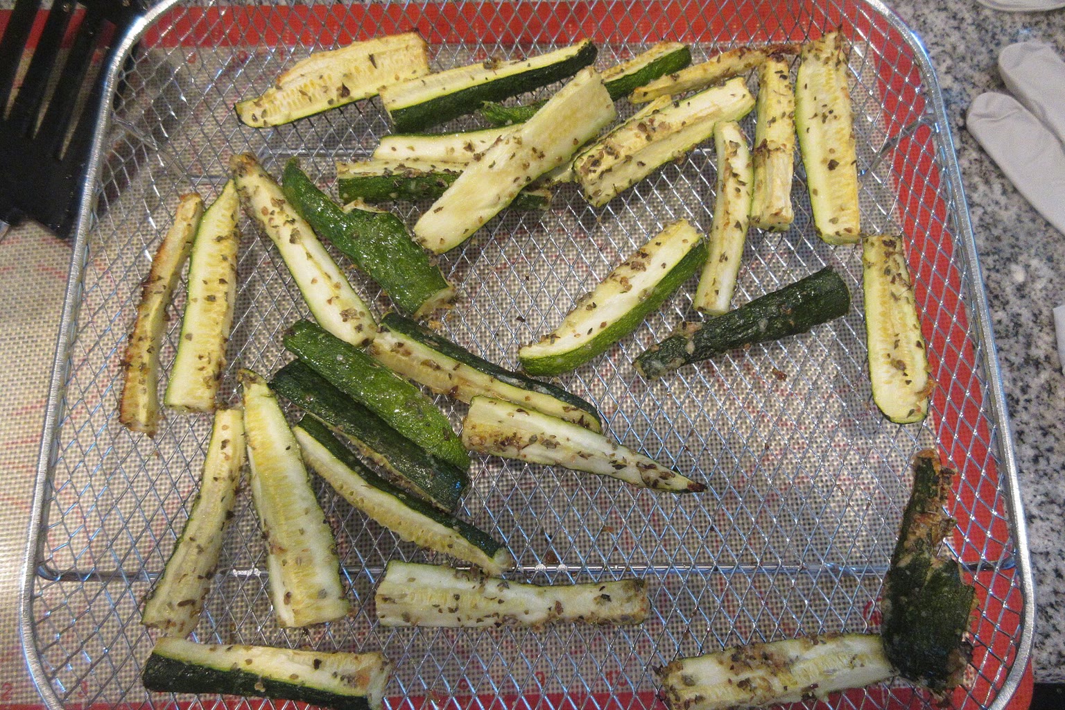 Air fryer basket with roasted vegetables