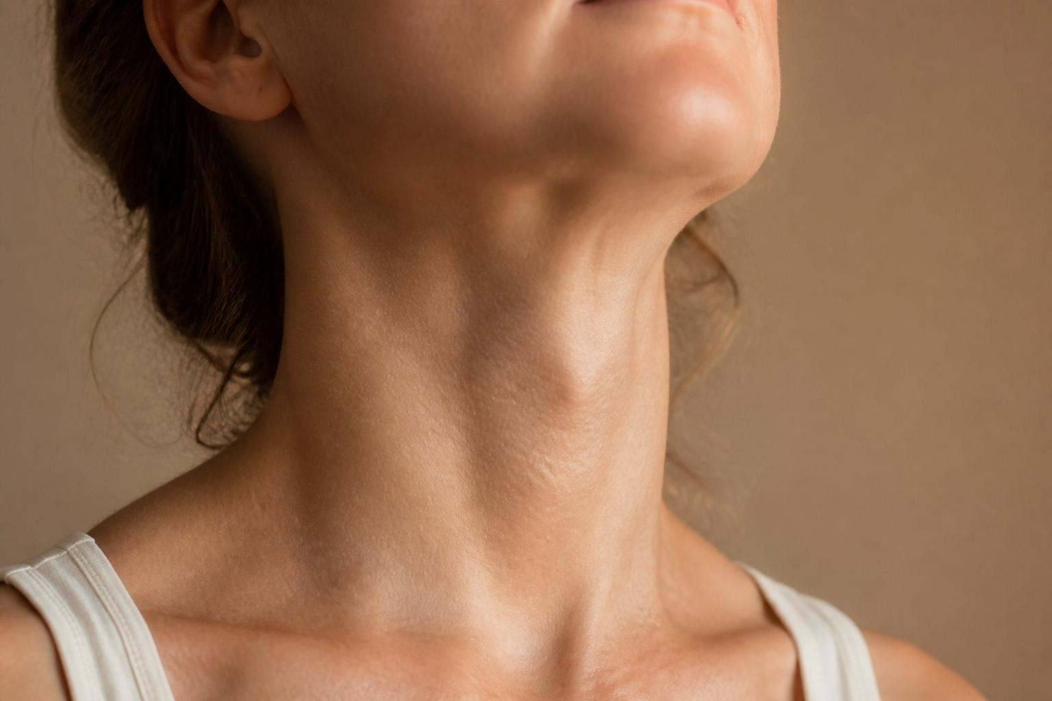 Close-up of a person's throat and chin area