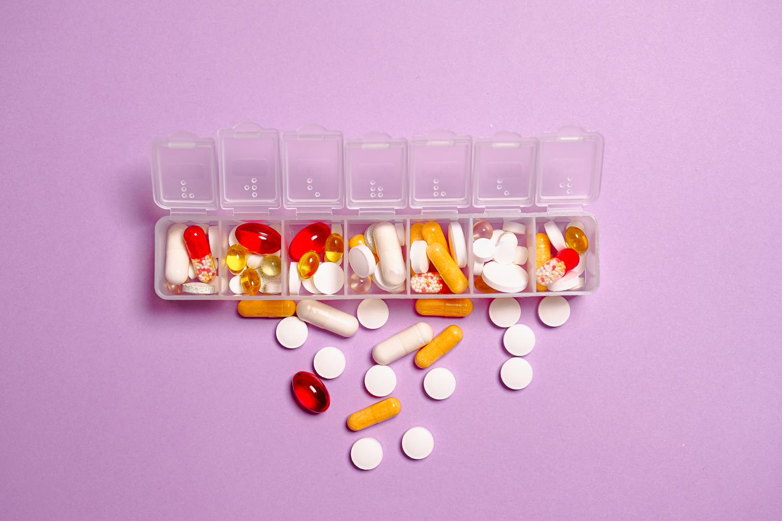 Row of colorful supplement capsules