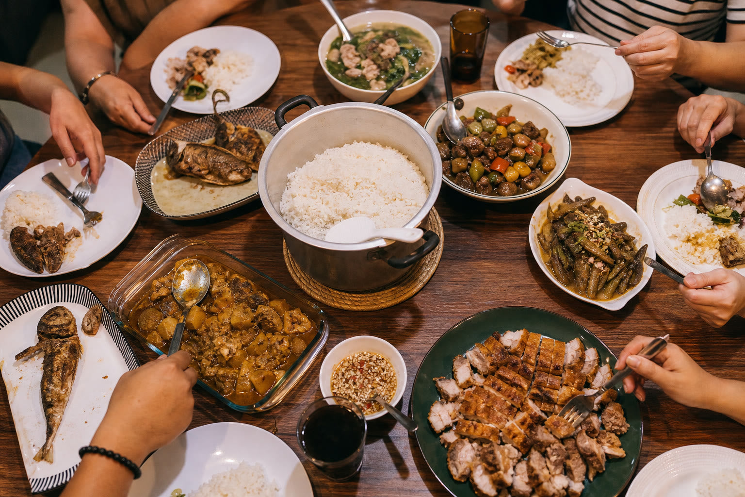 Filipino family dinner table with shared dishes and rice