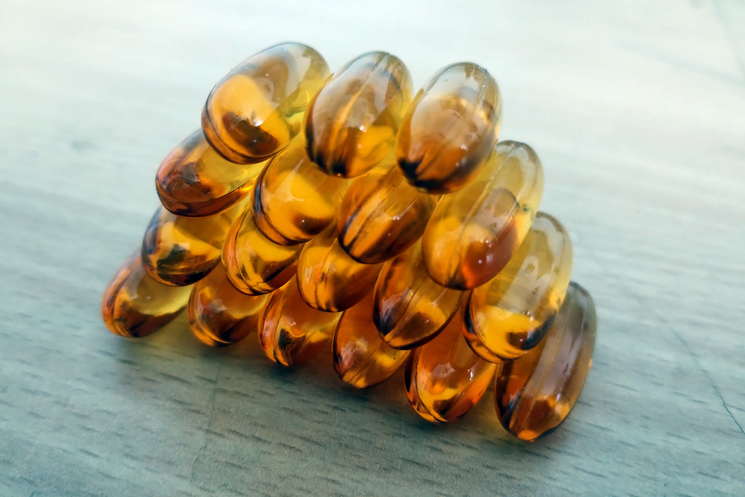 Fish oil softgel capsules on slate