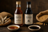 Bottles of patis and toyo with small condiment dishes