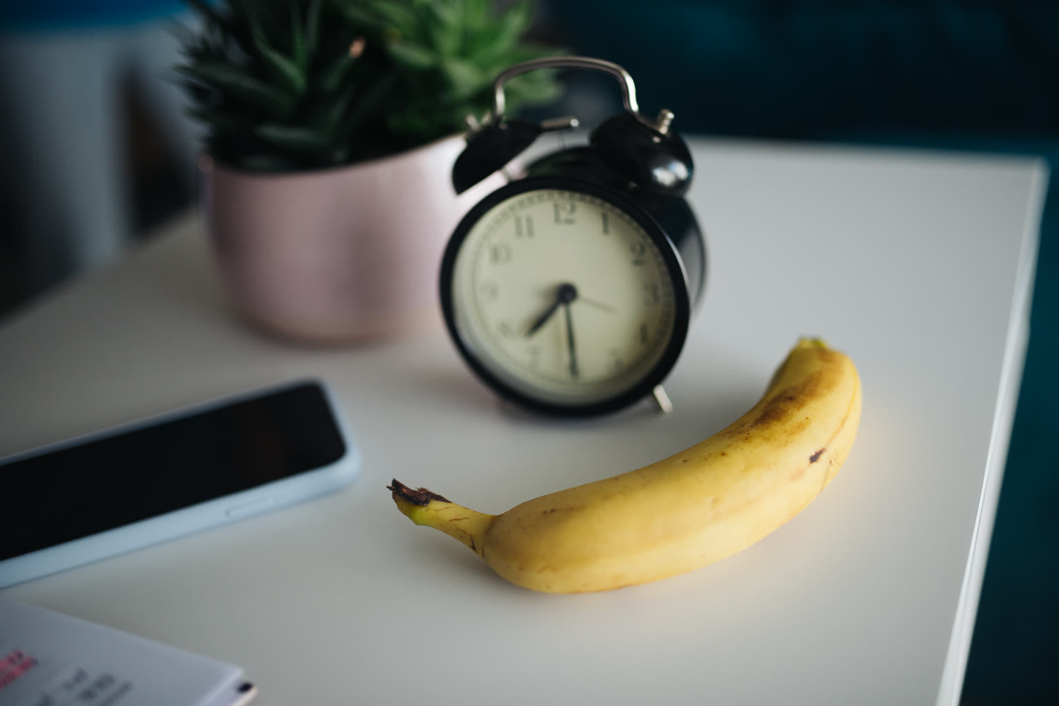 Alarm clock beside breakfast bowl