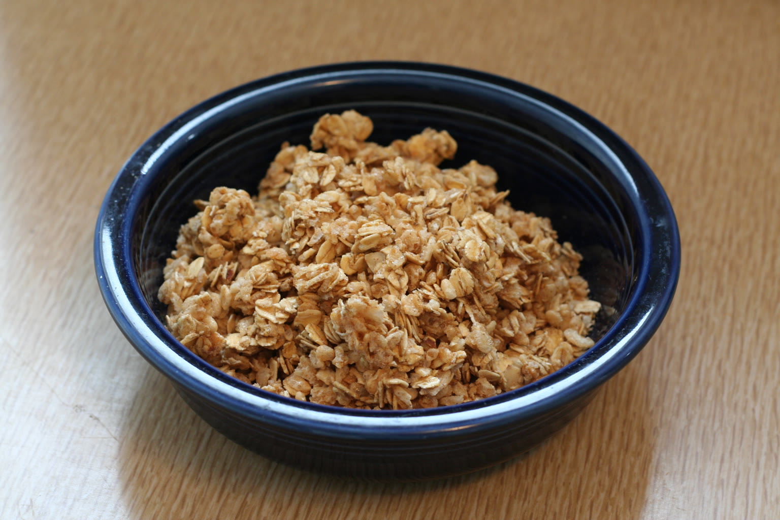 Honey granola clusters on dark wood