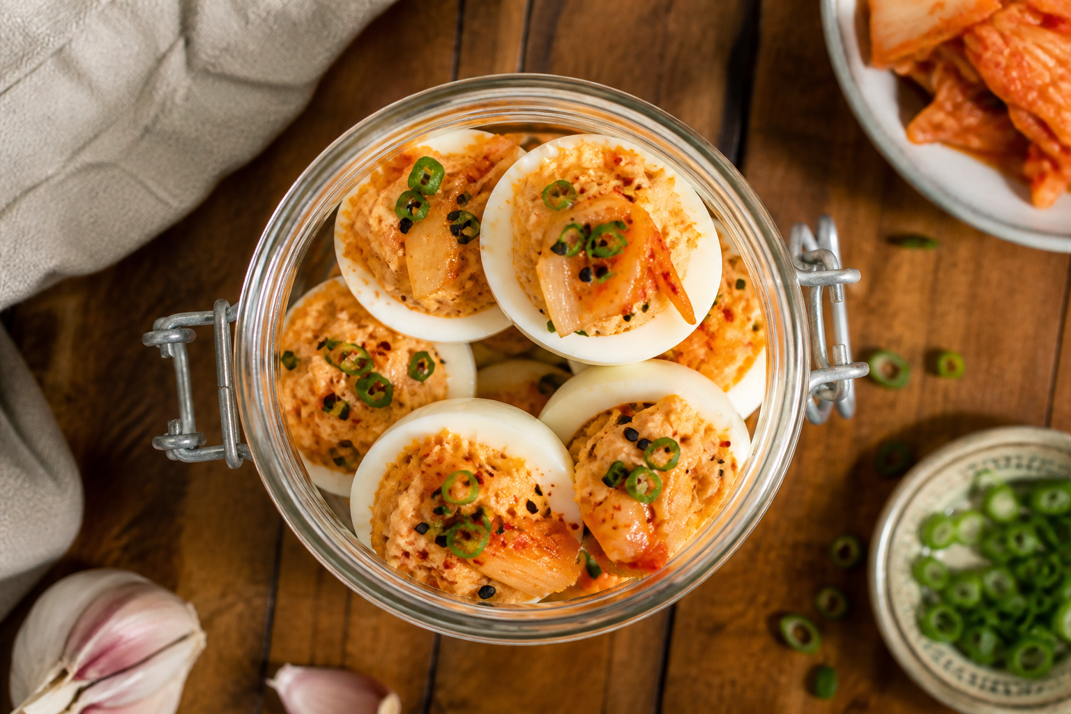 Overhead shot of Kimchi Deviled Eggs plated appetizingly in a mason jar