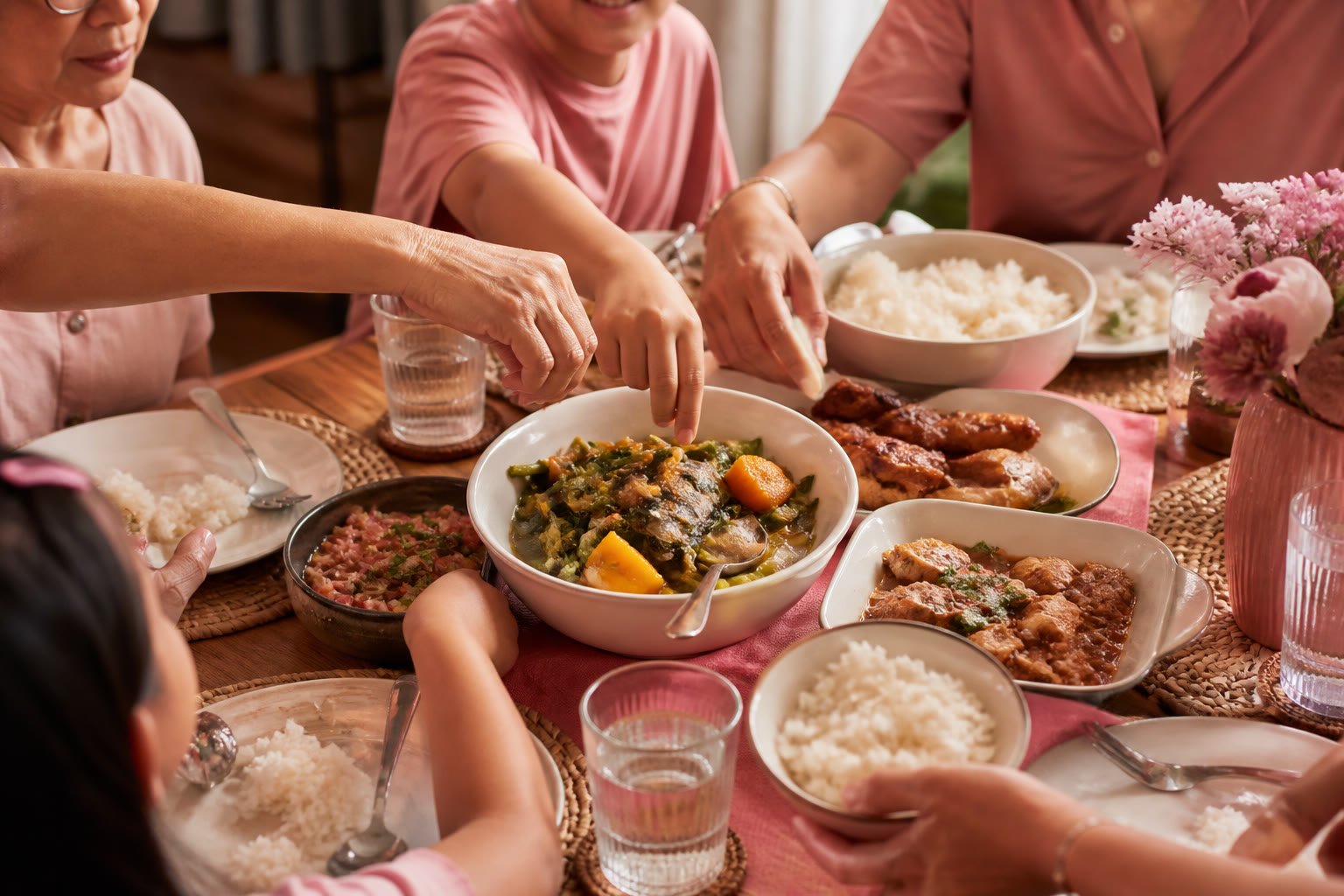 Filipino family dinner table with hands sharing food across generations