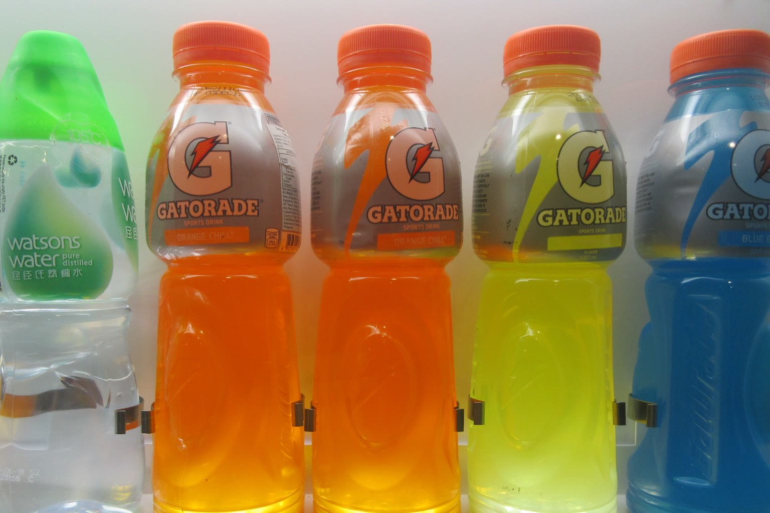 Water and sports drink on gym bench