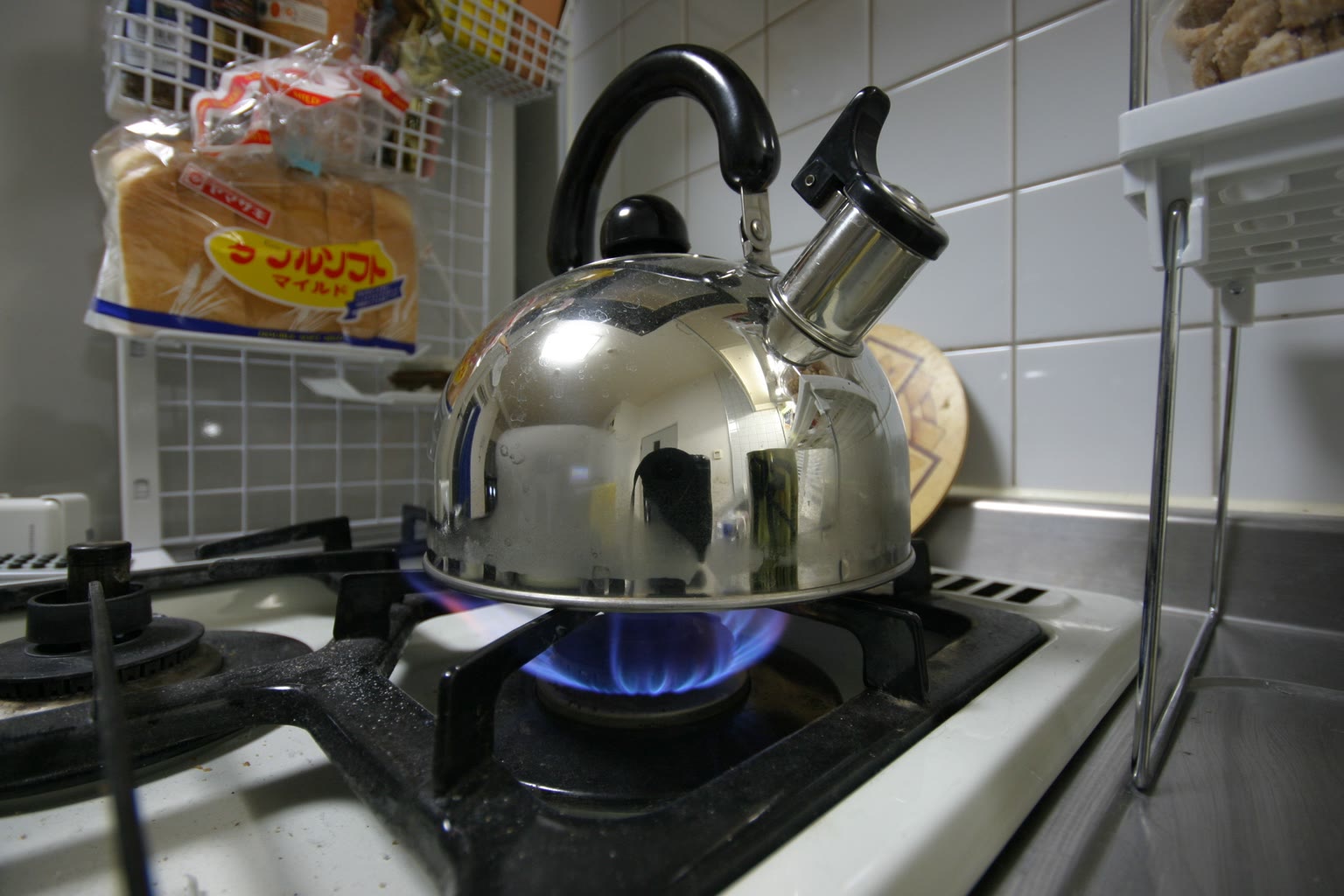 Kettle on stove with faint steam rising